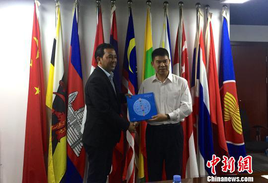 中國(guó)—東盟博覽會(huì)秘書處副秘書長(zhǎng)黃平西（右）與柬埔寨新聞部新聞與傳播總司副總司長(zhǎng)春占皮侖（左）互贈(zèng)禮物。